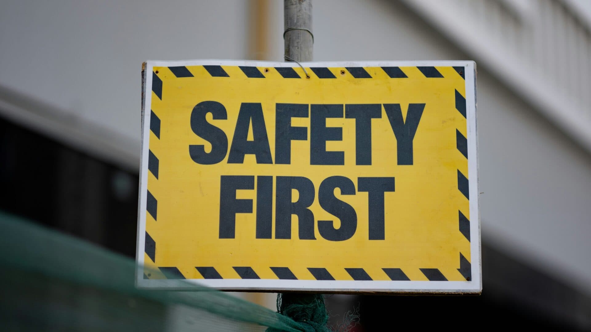 Industrial safety signage reading “Safety First” on a factory wall